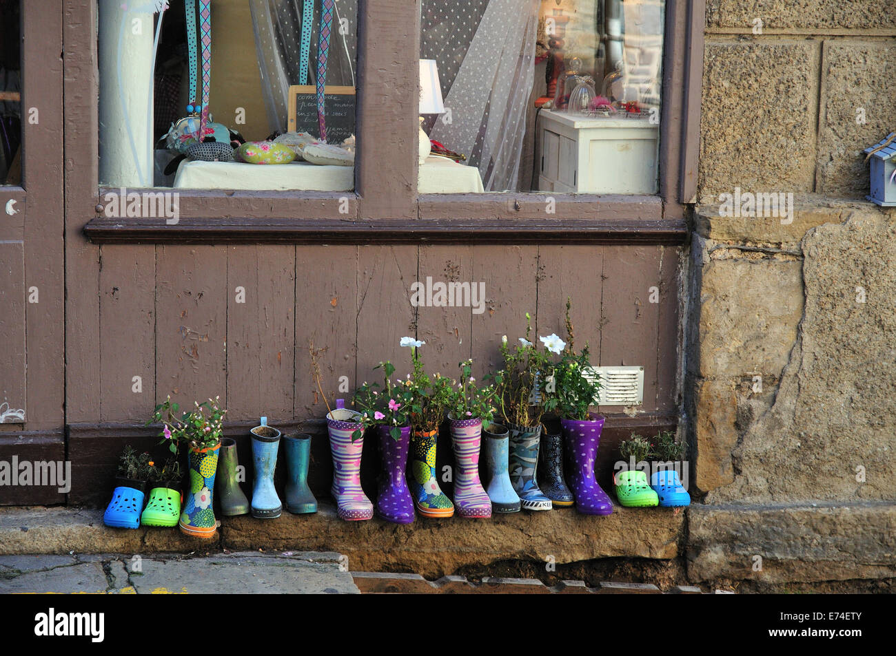 Wellingtons and shoes outside a shop in Estaing, France Stock Photo