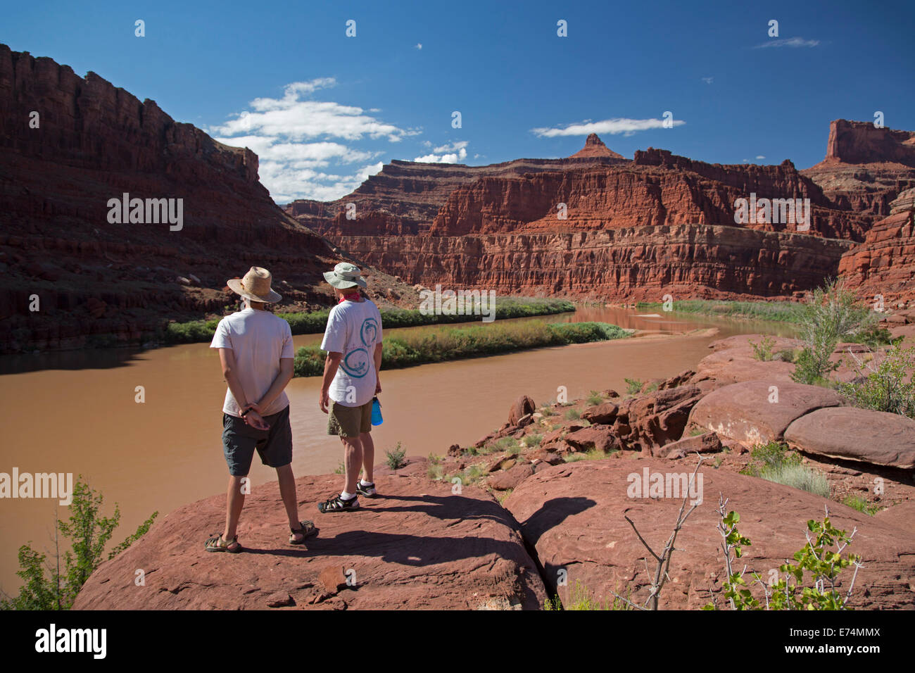 Canyonlands National Park, Utah - Two people stand above the Colorado River while on a river rafting trip. Stock Photo