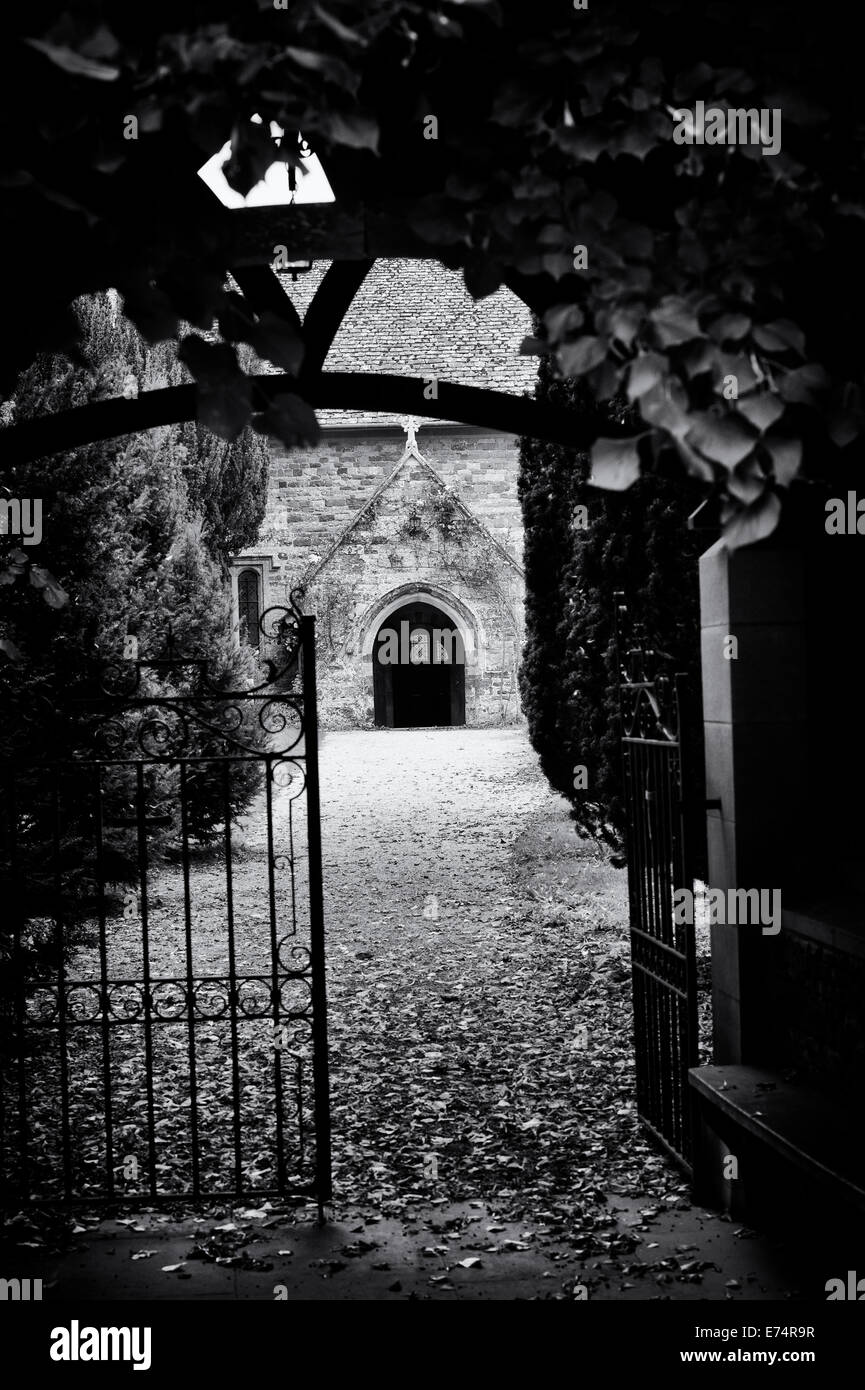 Duns Tew Parish Church entrance through the Lychgate. Oxfordshore, England. Monochrome Stock Photo