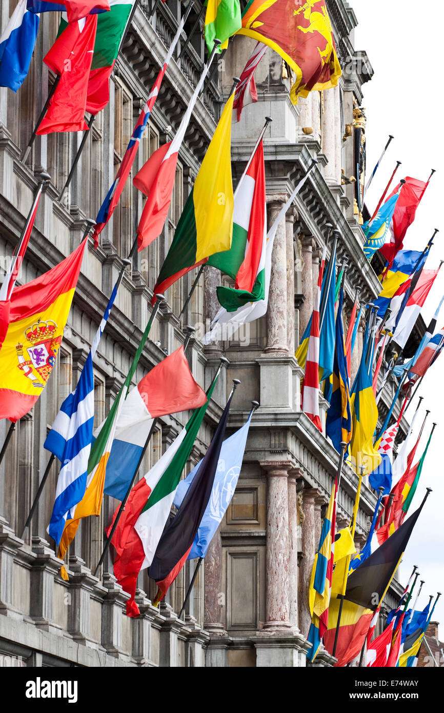 Flags of the world on display against the outside of the impressive Antwerp City Hall, Belgium Stock Photo