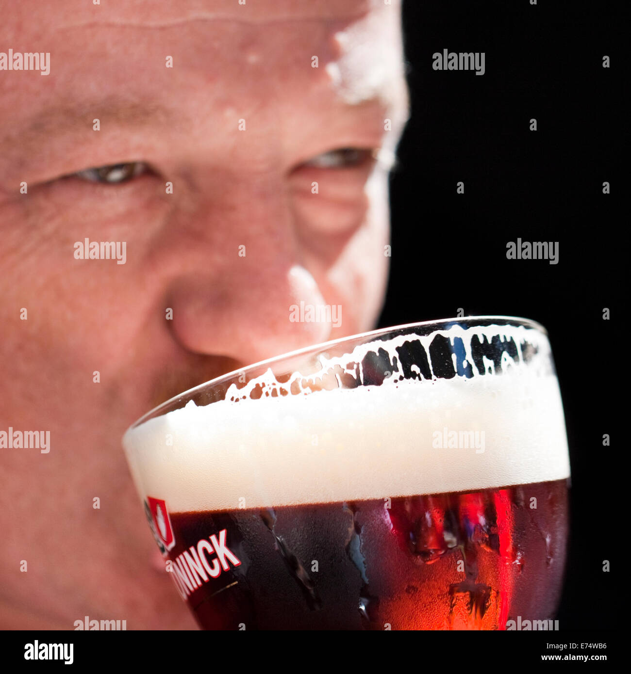 Man drinking glass ('Bolleke') of De Koninck amber ale in Antwerp, Belgium Stock Photo