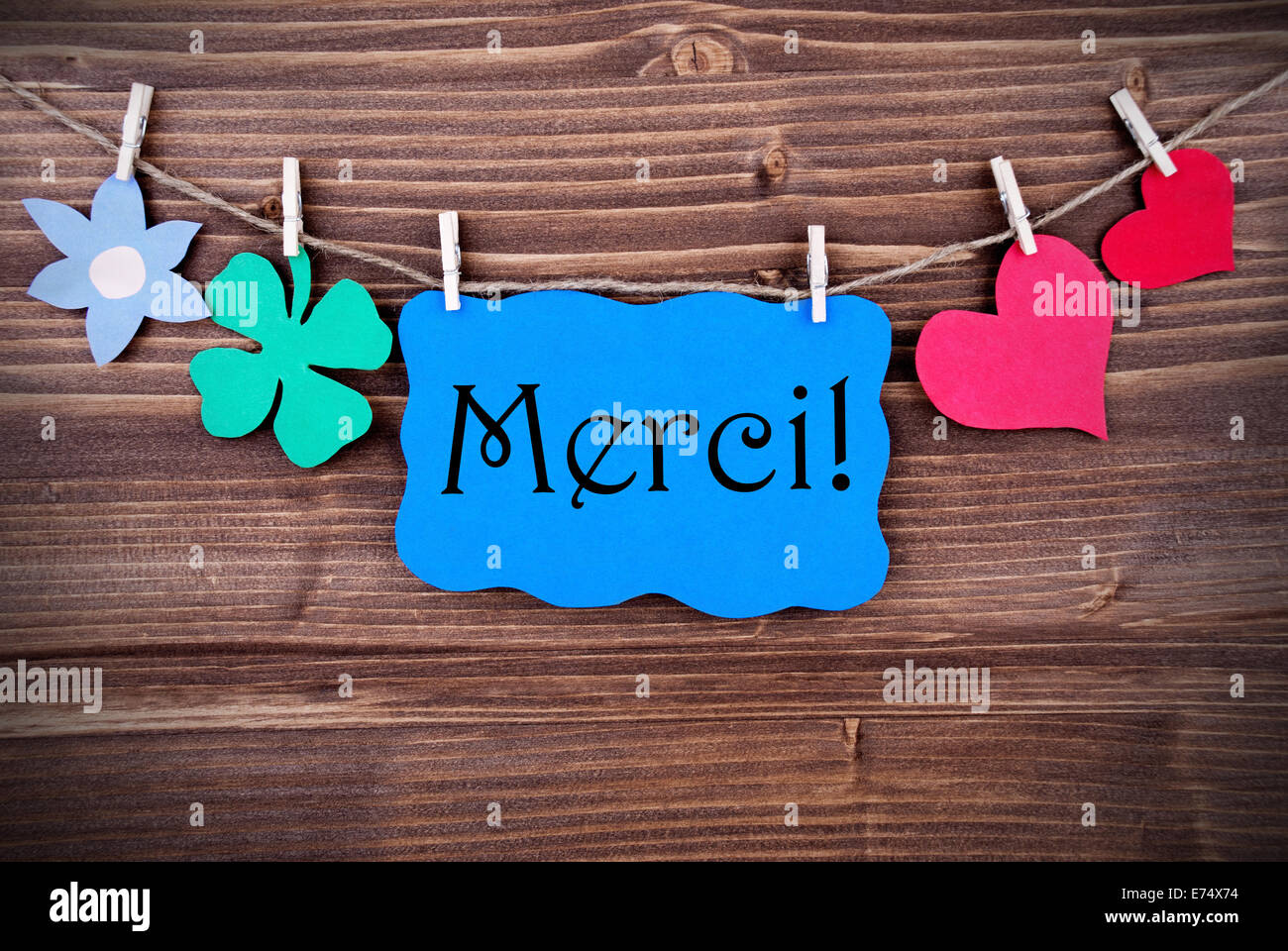Blue Banner with the French Word Merci, which means Thanks, on a Line
