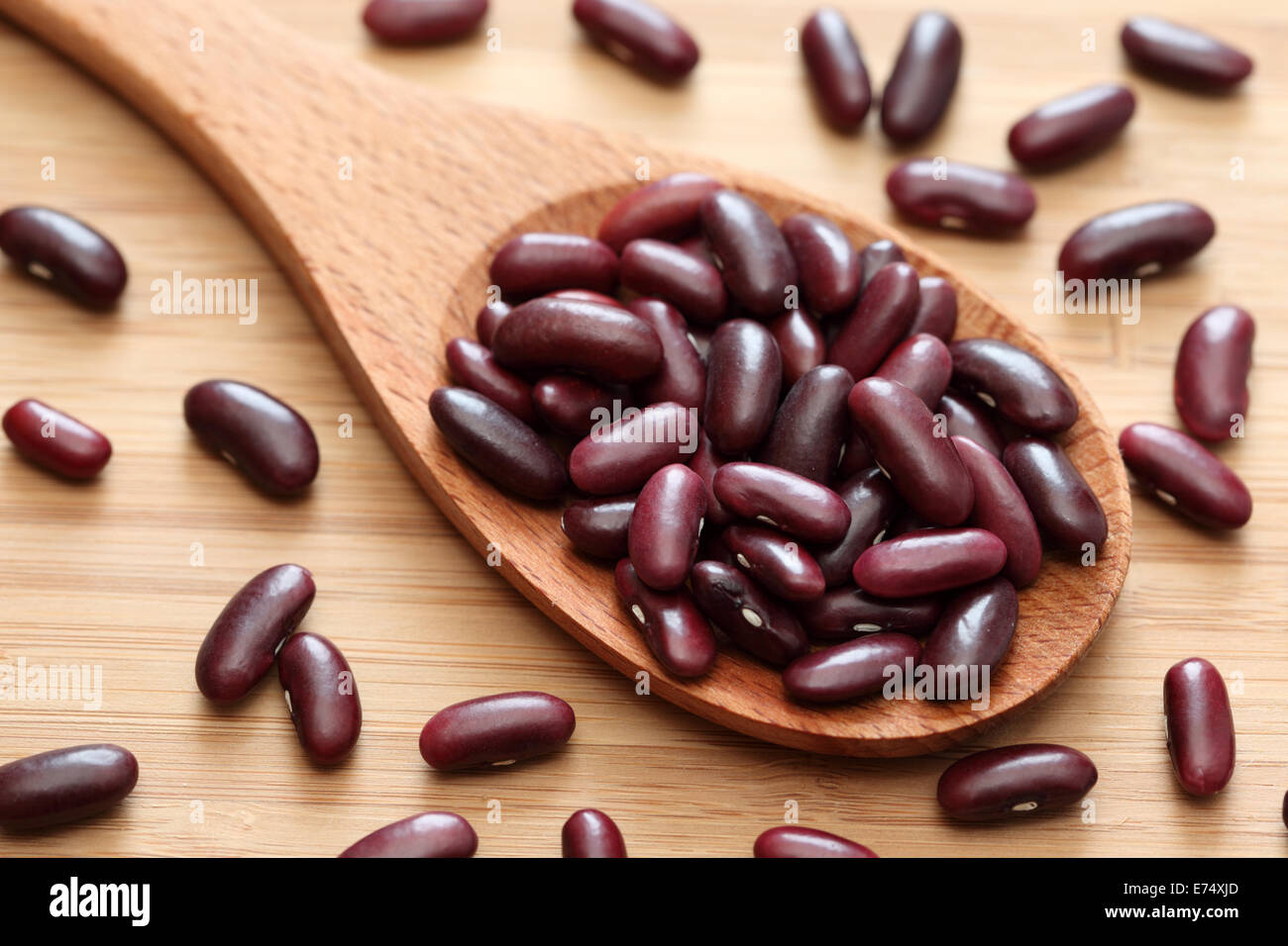 Red kidney bean in a wooden spoon. Close-up. Stock Photo