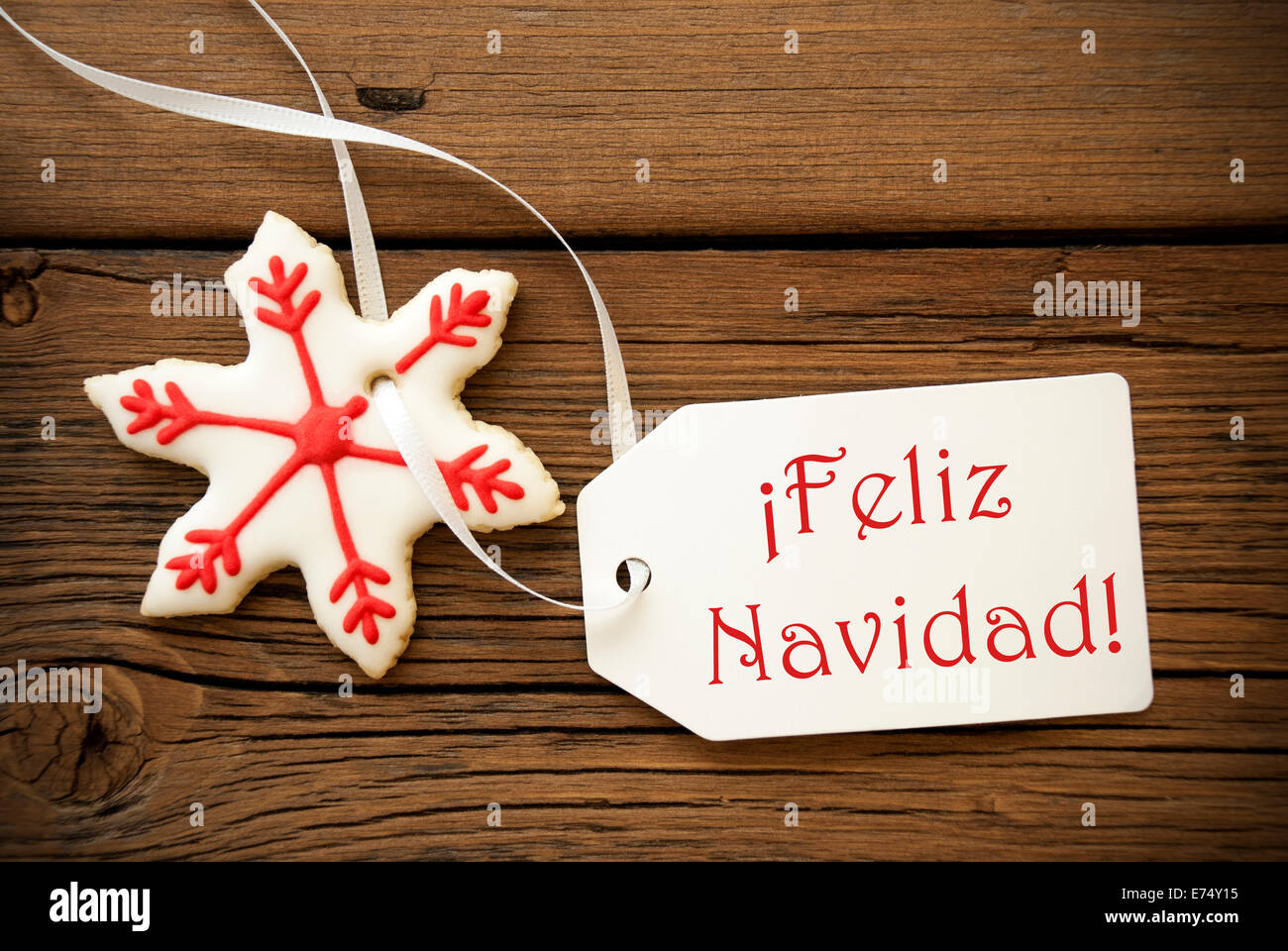 Feliz Navidad, which is Spanish and means Merry Christmas, on a Label with a red white Christmas Star Cookie Stock Photo