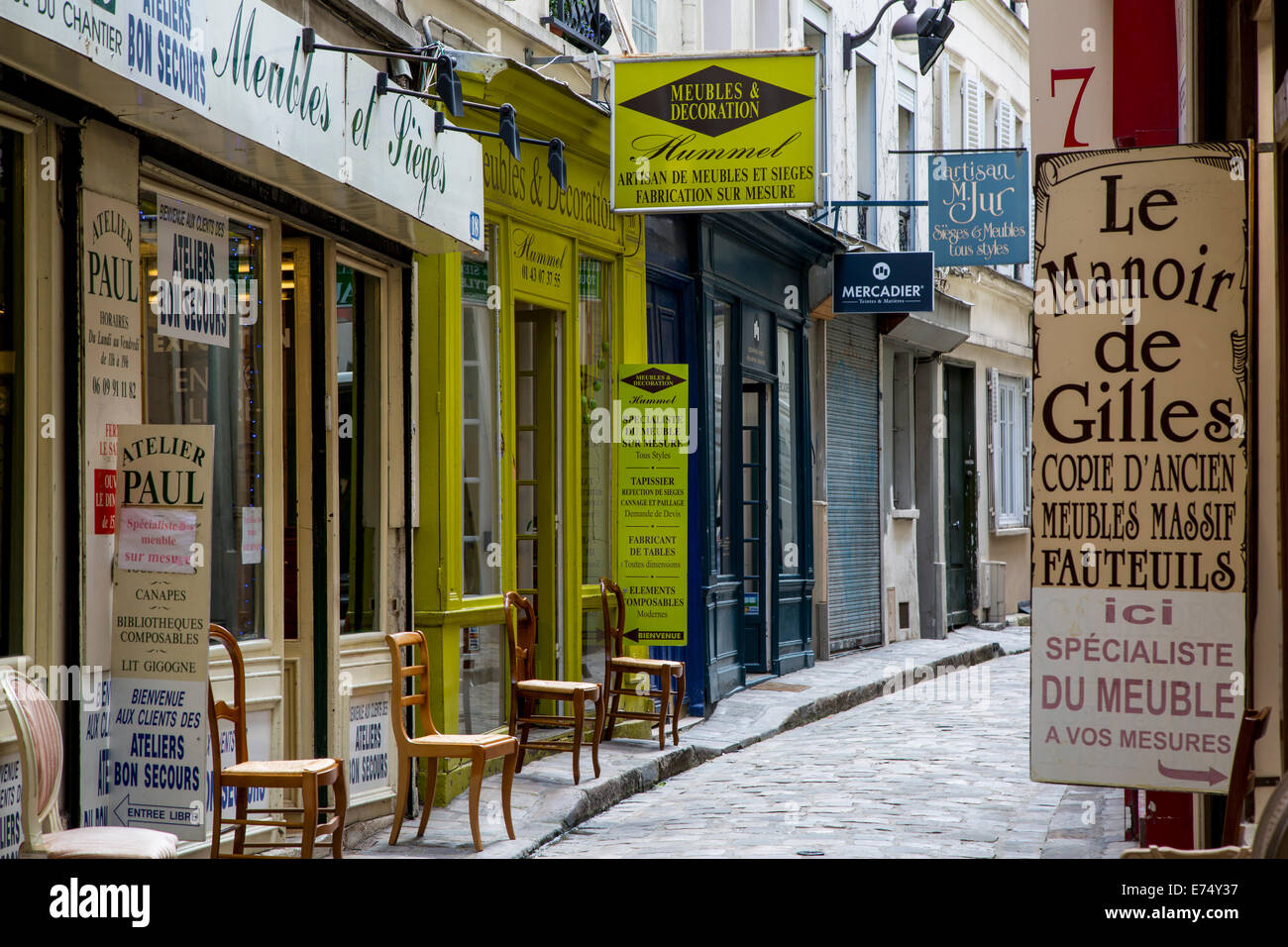 Furniture company signs along Passage du Chantier, near Faubourg Saint Antoine, Paris, France Stock Photo