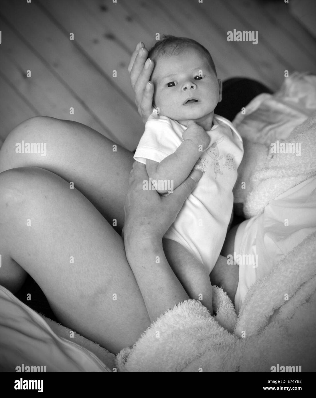 two week old baby in mother's arms Stock Photo