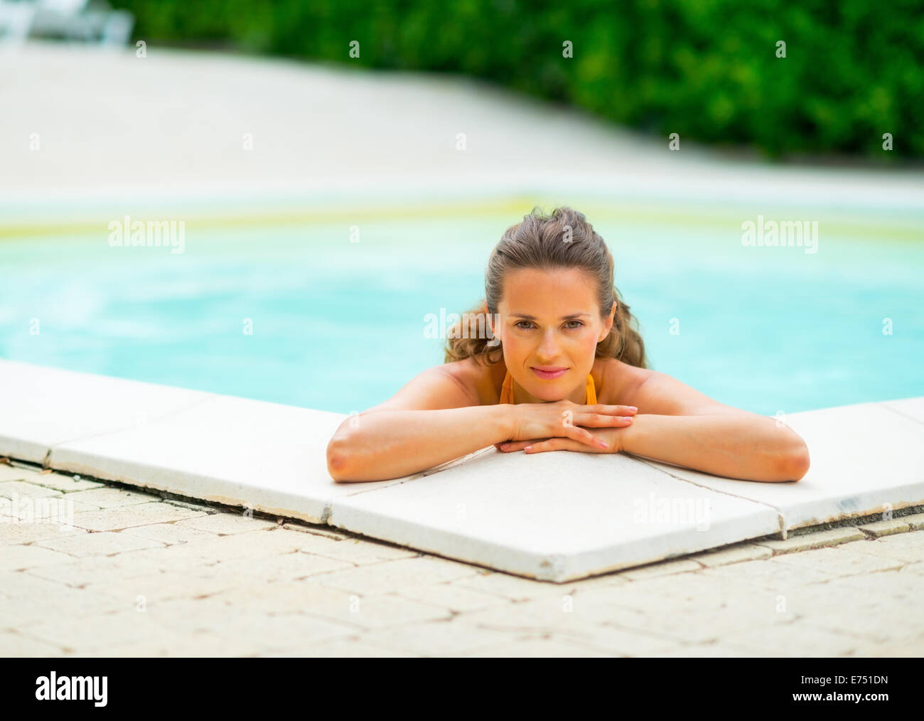 Portrait of happy young woman relaxing in swimming pool Stock Photo - Alamy