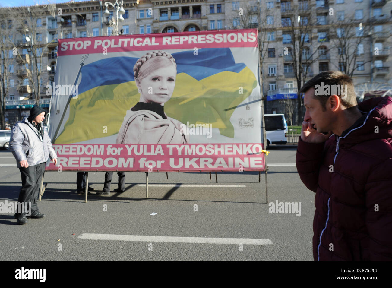 Ukrainian protesters carry a banner calling for the release of Yulia Tymoshenko during the protests in Maidan in December 2013. Stock Photo