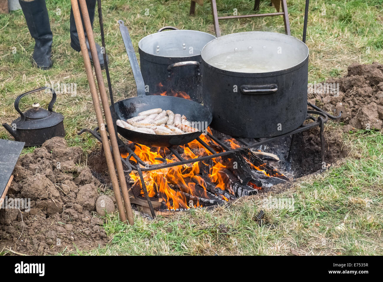 Sausages cooking on an open fire at a battle reenactment event, Leicestershire, England Stock Photo