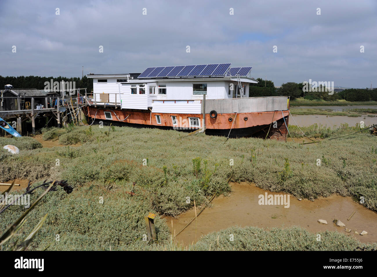 Shoreham West Sussex UK - A houseboat with solar panels for energy on the River Adur Shoreham Beach Stock Photo