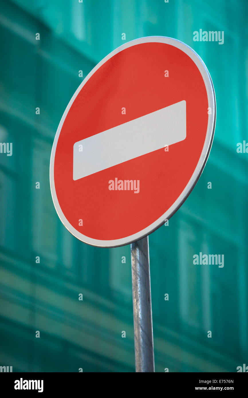 Red stop sign on construction green net on background Stock Photo