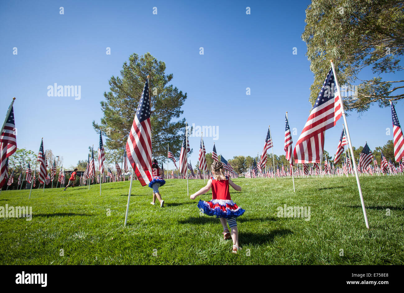 Children running through a field of American Flags in Freedom Park in