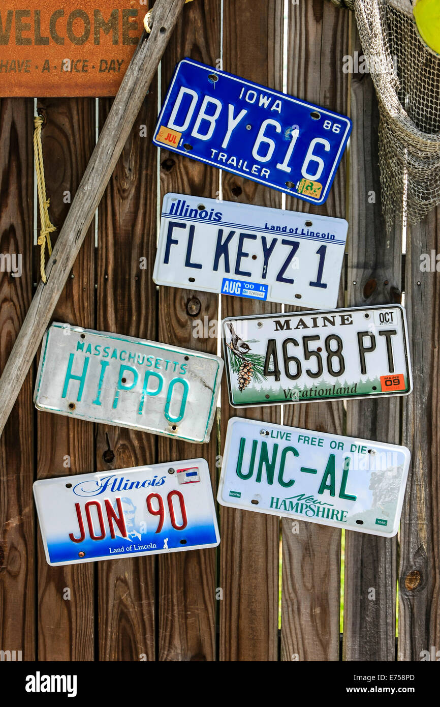 Vehicle number plates from various states nailed to a fence Stock Photo
