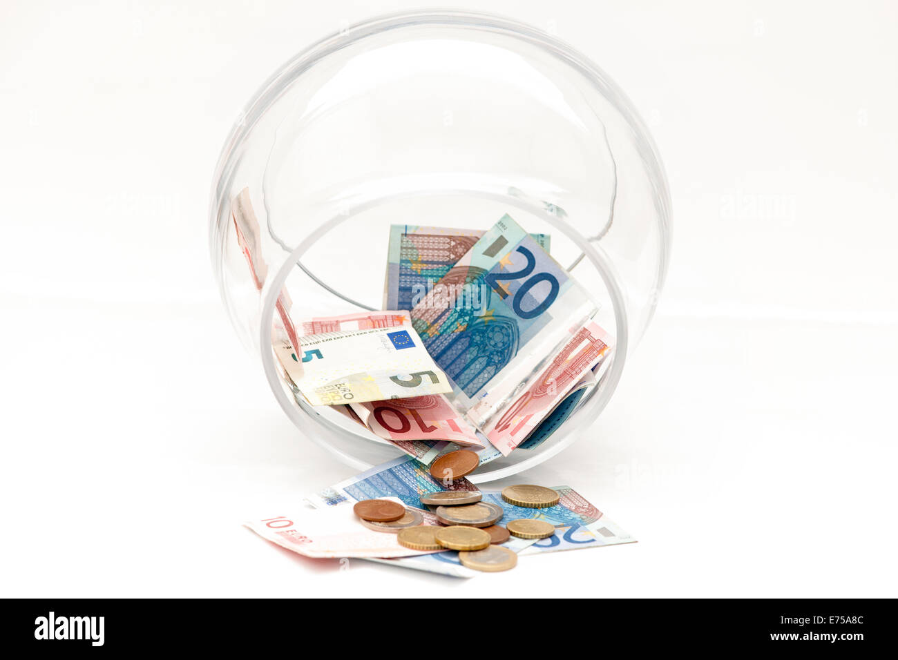 A glass piggy bank with euro banknotes is almost empty Stock Photo - Alamy