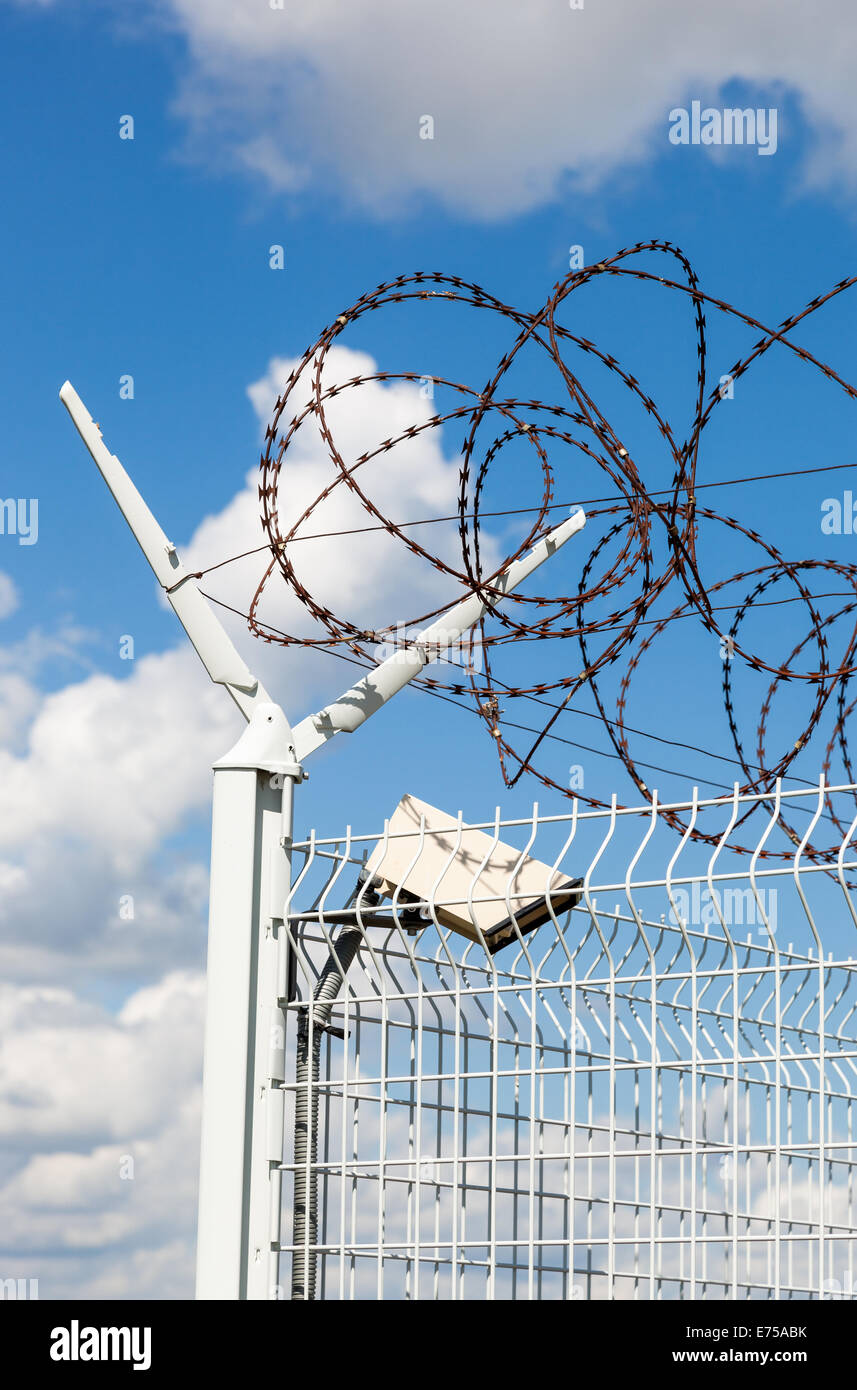 Barbed wire on blue sky background Stock Photo - Alamy