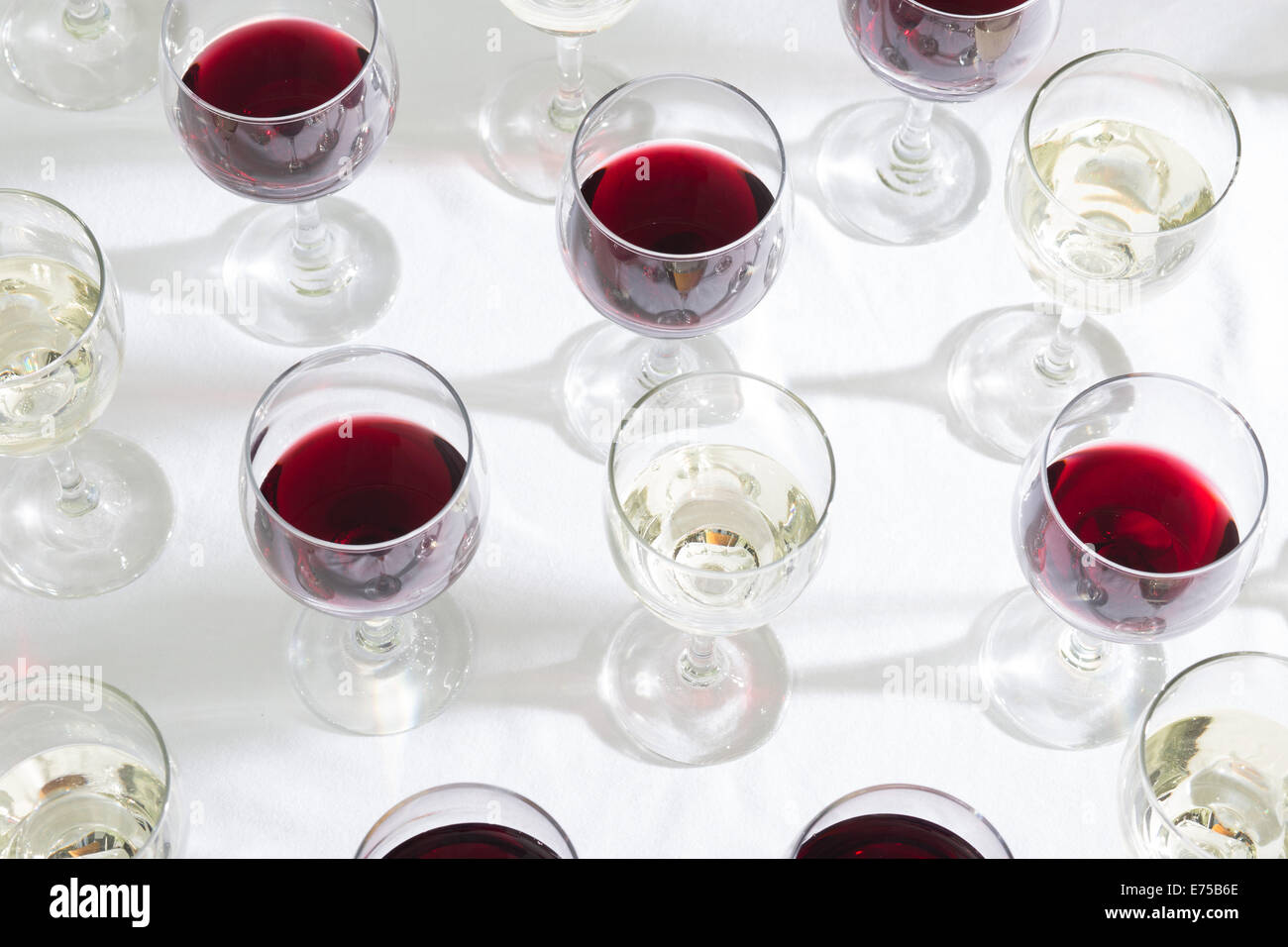 An array of wine glasses filled with different wines. Stock Photo