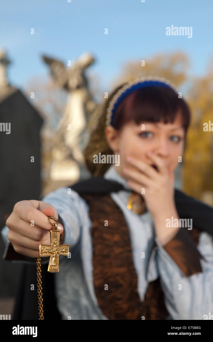 Young victorian woman trying to keep evil away in a graveyard Stock ...