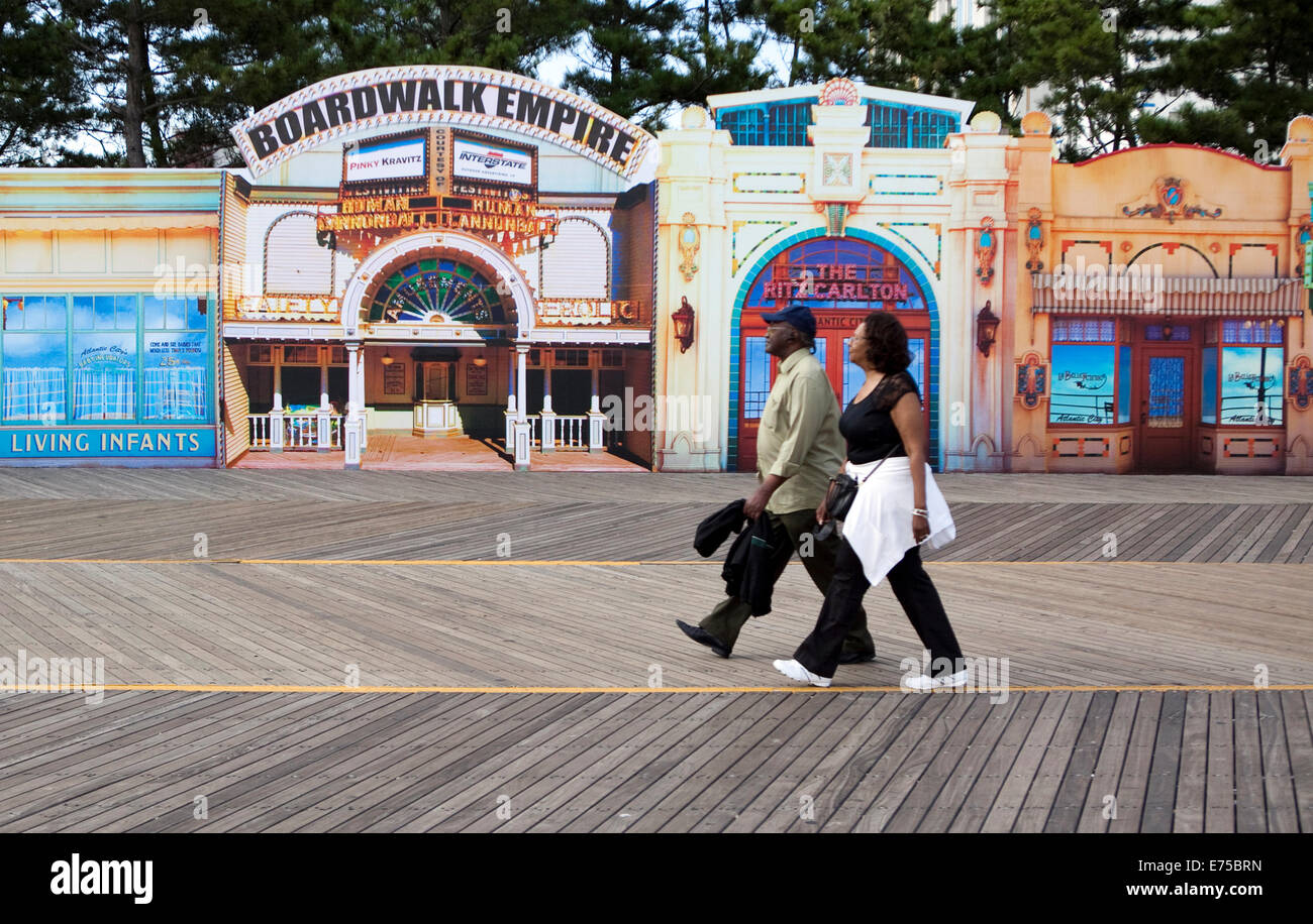 People walk in front of a display for tv show Boardwalk Empire on the boardwalk at Atlantic City, New Jersey Stock Photo