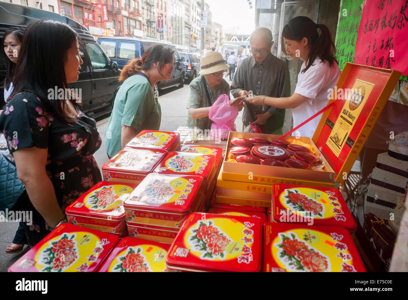 New York, USA. 7th September, 2014. Shoppers in Chinatown in New York buy boxes of mooncakes on Sunday, September 7, 2014 for the Mid-Autumn Festival which occurs on September 8. The delicious traditional baked product is eaten during the Mid-Autumn festival and are popular as gifts. The perfectly round pastries can be sweet or savory, filled with lotus seed or salted duck egg. The cakes represent the full moon on the eighth month, the fifteenth day in the Chinese (lunar) calendar. Credit:  Richard Levine/Alamy Live News Stock Photo