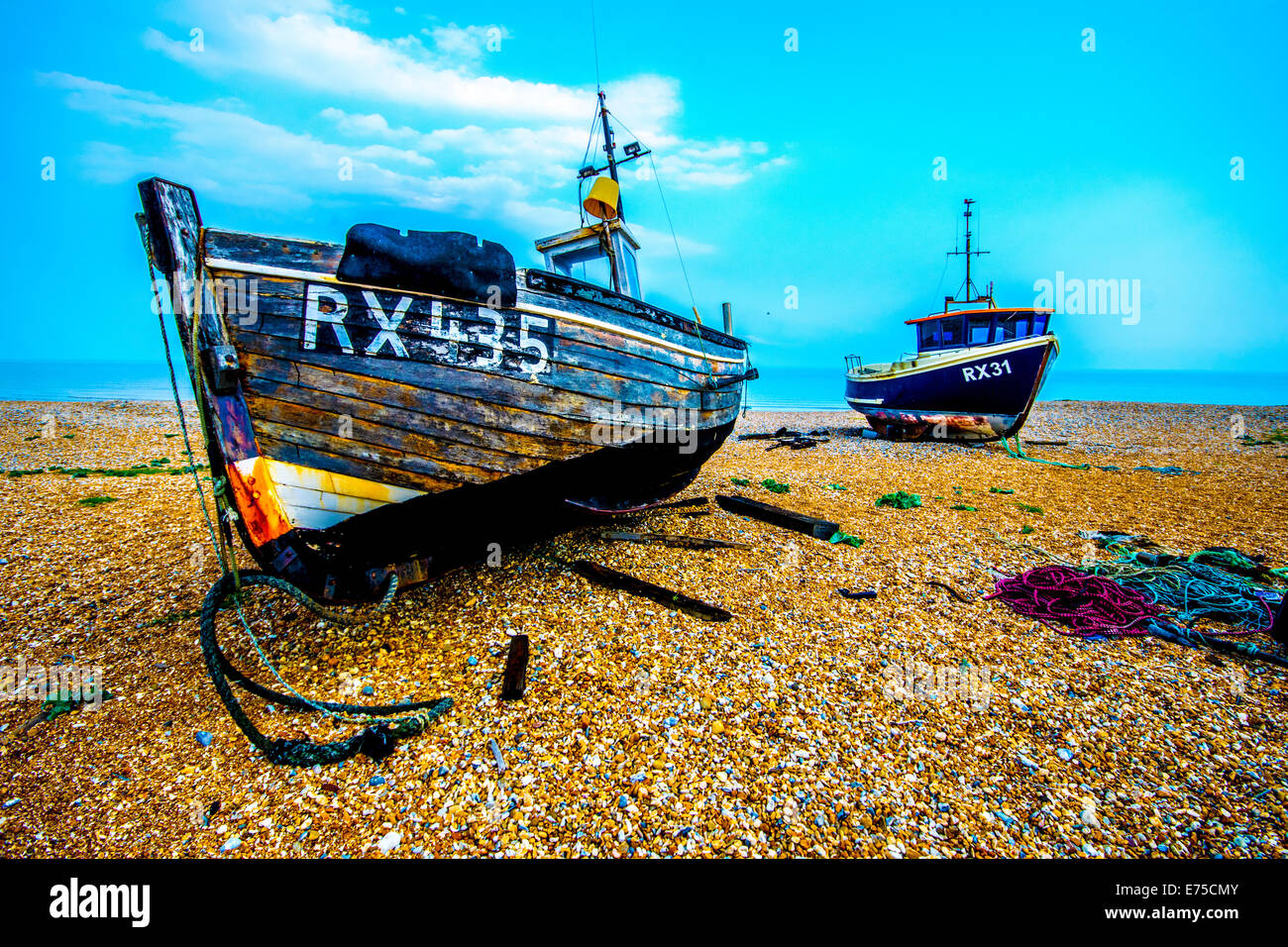 The abandoned fishing boats and railway tracks on the beach at ...