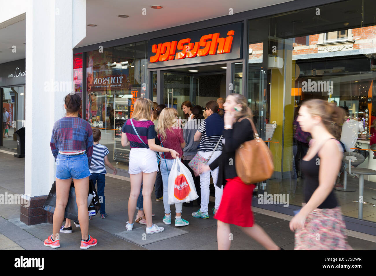 People queuing up to get into Yo! Sushi restaurant, Cambridge, England Stock Photo
