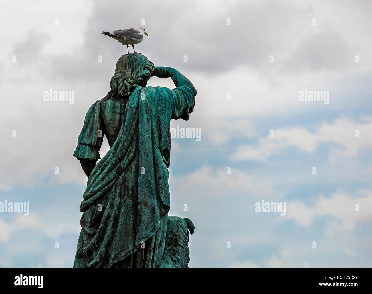 Statue of Flora Macdonald, seen from behind, with a seagull on his head. Stock Photo