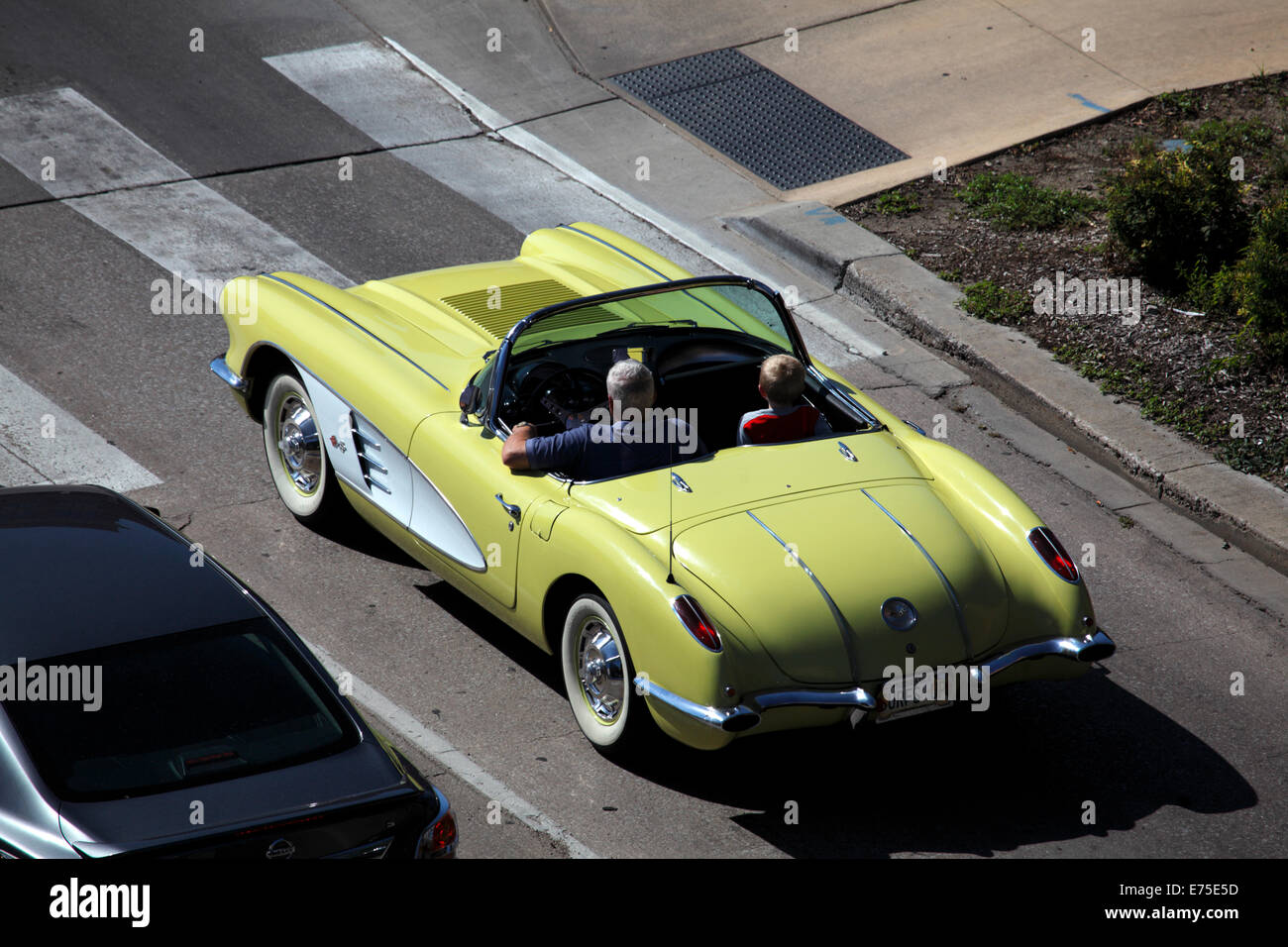 White haired man and child in convertible roadster. Stock Photo