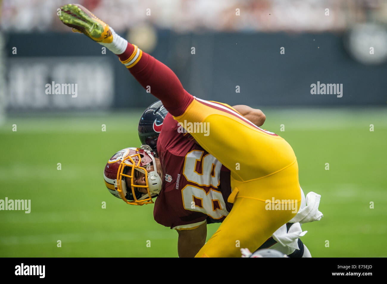 Houston, Texas, USA. 7th Sep, 2014. Washington Redskins tight end Jordan Reed (86) takes a hit from Houston Texans inside linebacker Brian Cushing (56) while being tripped up by Houston Texans strong safety D.J. Swearinger (36) during the 1st half of an NFL game between the Houston Texans and the Washington Redskins at NRG Stadium in Houston, TX on September 7th, 2014. Credit:  Trask Smith/ZUMA Wire/Alamy Live News Stock Photo