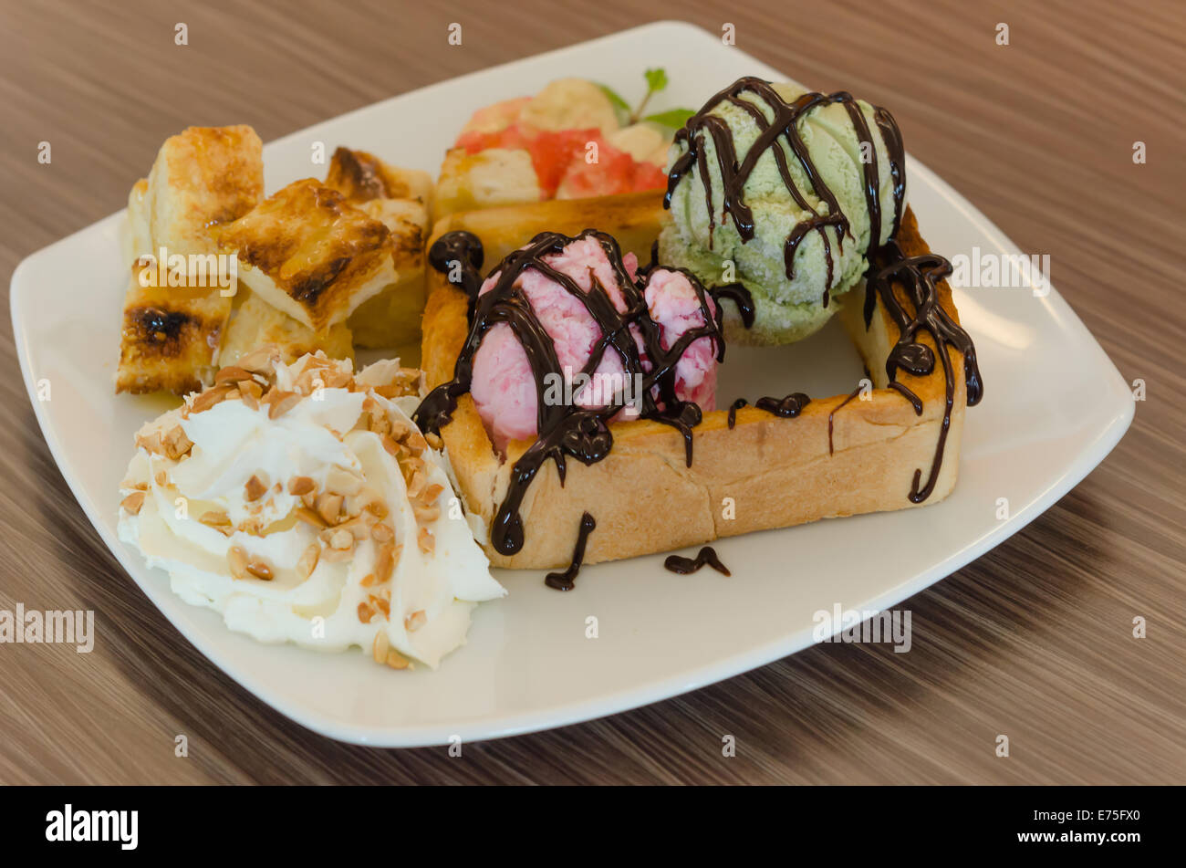 Honey toast and whipping cream with chocolate  sauce and ice cream Stock Photo