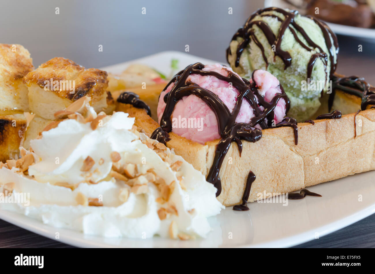 Honey toast and whipping cream with chocolate  sauce and ice cream Stock Photo