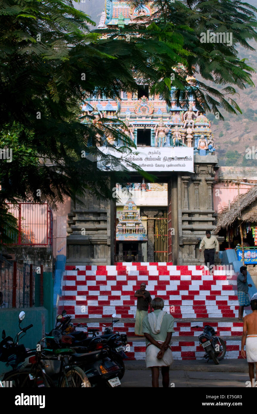 Hindu Temple entrance steps with colourful gopuram (tower) entrance at the foot of the sacred hill of Arunachala South India Stock Photo