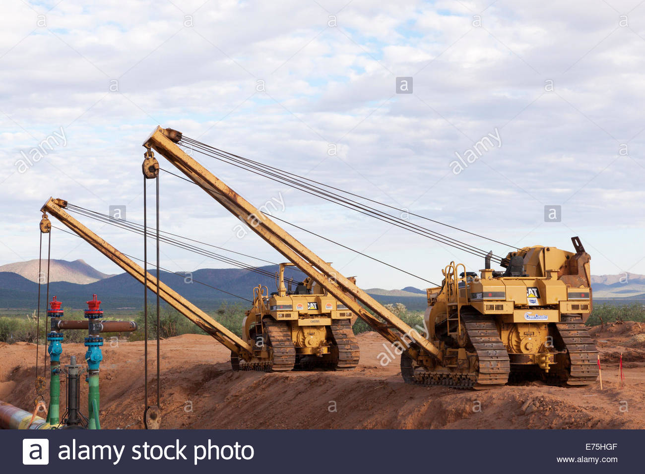 Two Caterpillar CAT 583T sideboom pipelayers holding 3 foot pipeline