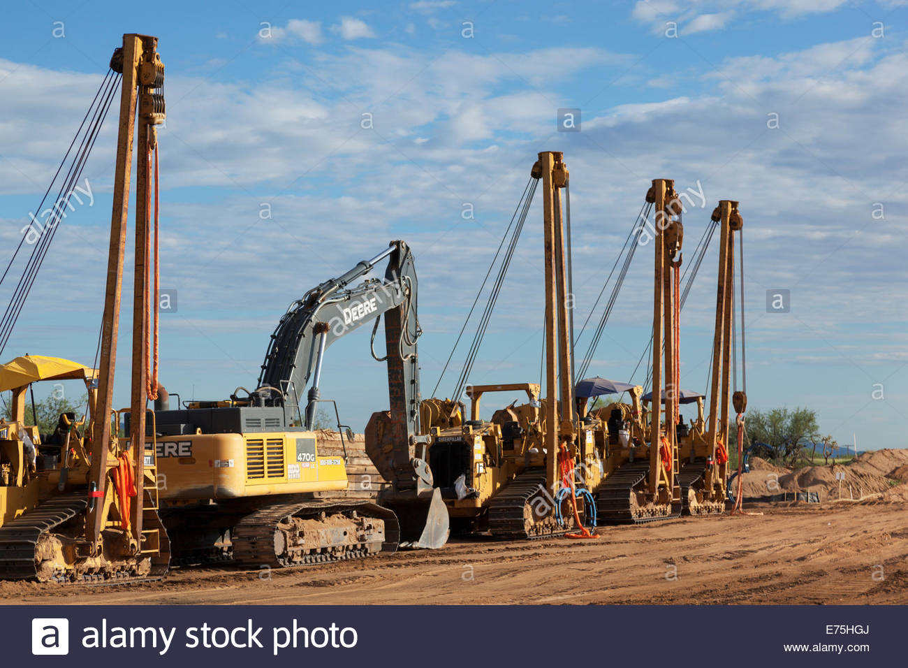 Pipeline construction equipment in row includes sideboom pipelayers