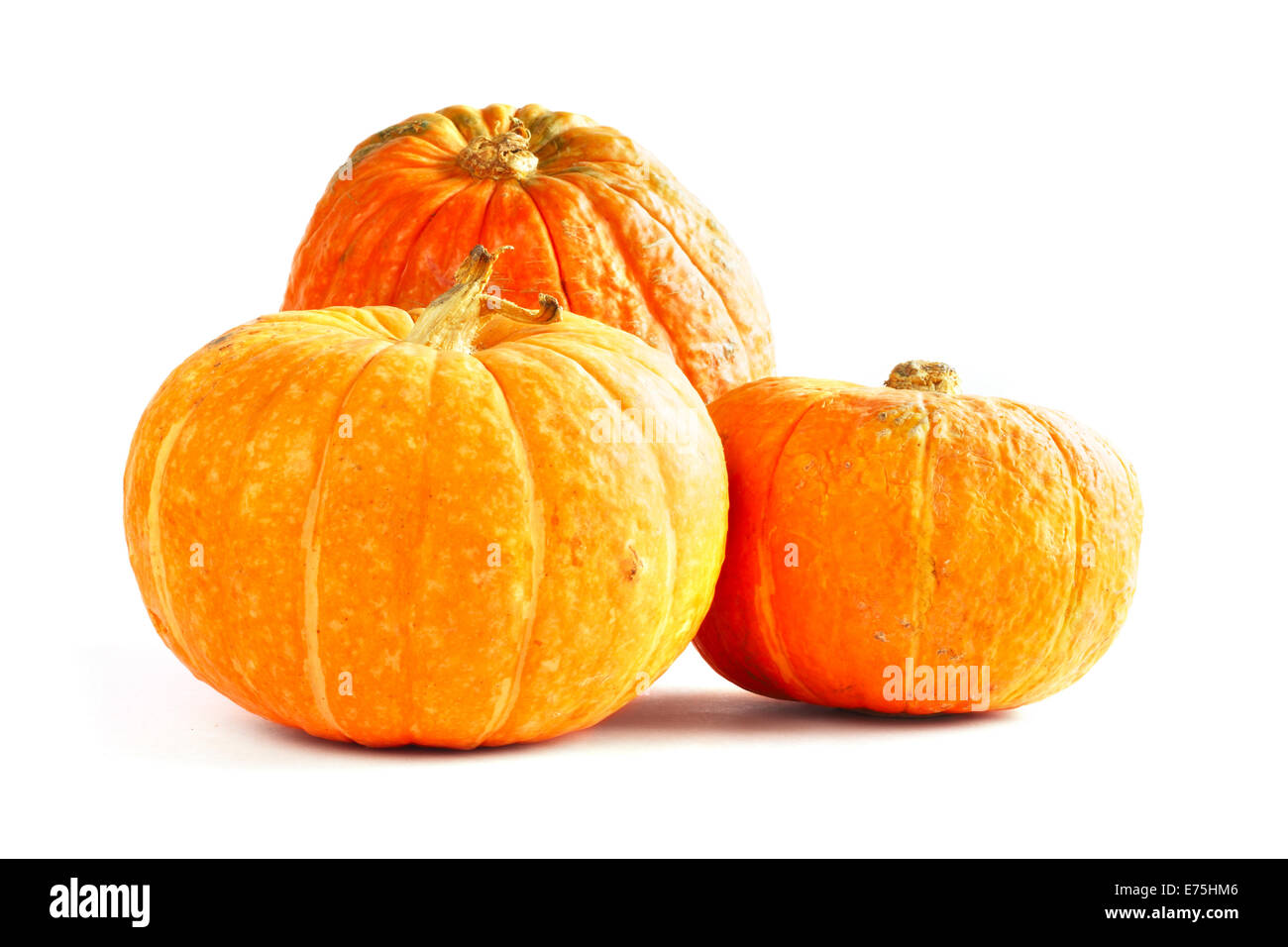 Three orange pumpkins isolated on white background Stock Photo - Alamy
