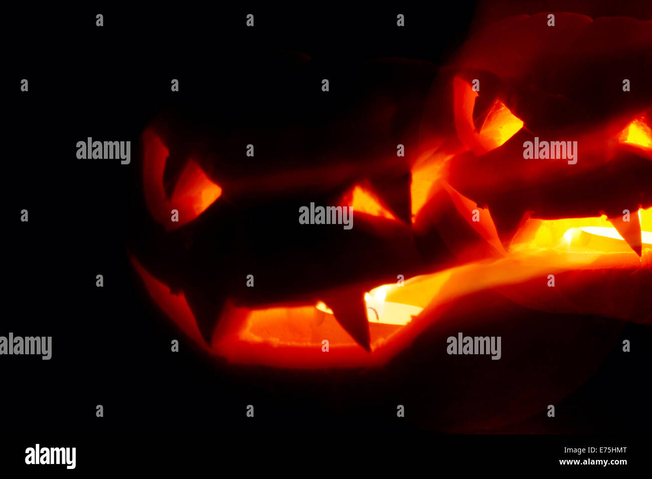 Illuminated cute halloween pumpkin isolated on black background Stock ...