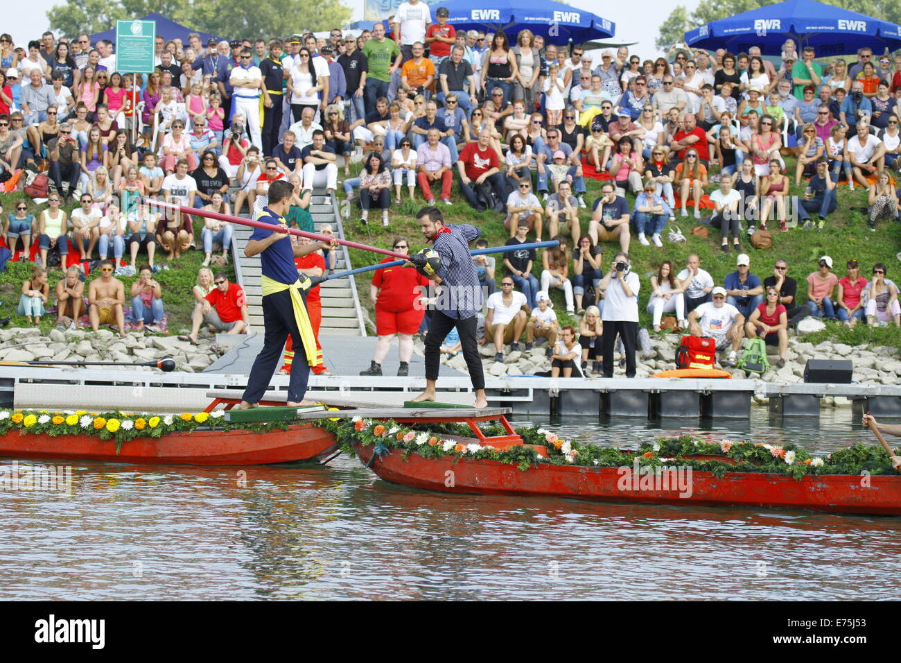Two opponents try to push each other into the river. Fifteen teams each consisting of 2 rowers and one man fighting with a lance, competed in the 65th anniversary Fischerstechen (Fishermen's Joust) held on the final day of the Backfischfest. © Michael Debets/Pacific Press/Alamy Live News Stock Photo
