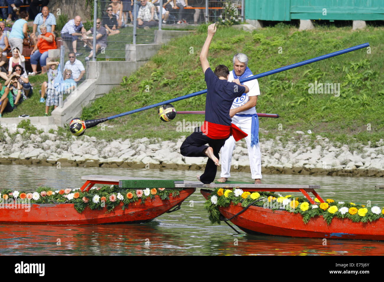 A competitor falls into the river after being pushed by his opponent. Fifteen teams each consisting of 2 rowers and one man fighting with a lance, competed in the 65th anniversary Fischerstechen (Fishermen's Joust) held on the final day of the Backfischfest. © Michael Debets/Pacific Press/Alamy Live News Stock Photo