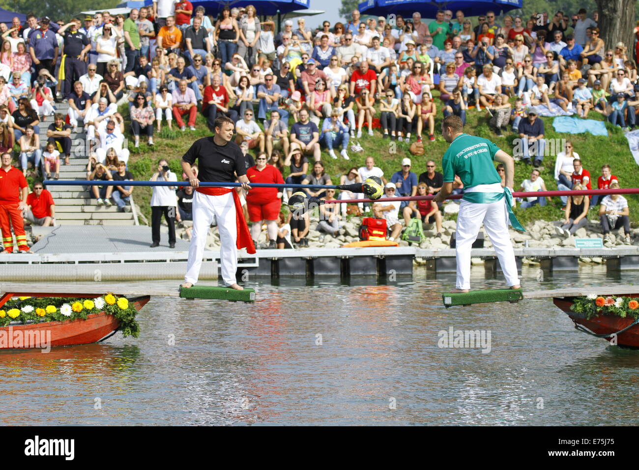 Two opponents try to push each other into the river. Fifteen teams each consisting of 2 rowers and one man fighting with a lance, competed in the 65th anniversary Fischerstechen (Fishermen's Joust) held on the final day of the Backfischfest. © Michael Debets/Pacific Press/Alamy Live News Stock Photo