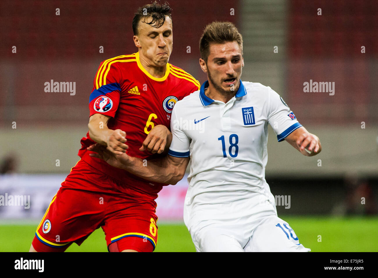 Players in action. Romania beats 1-0 Greece for the European Championship  2016 qualifying round. Karaiskaki Stadium, in central Athens, was empty  after the penalty that UEFA punished Greek Federation. © Andreas  Papakonstantinou/Pacific