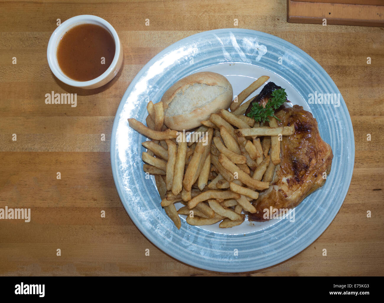 Quarter Chicken Dinner with Fries at Swiss Chalet Restaurant Stock