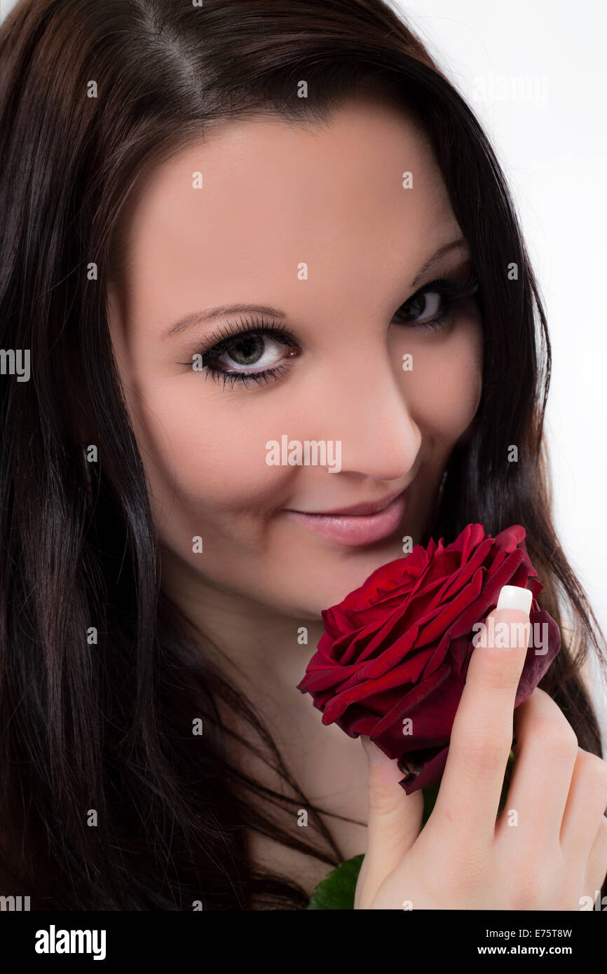 Smiling young woman with a red rose Stock Photo - Alamy