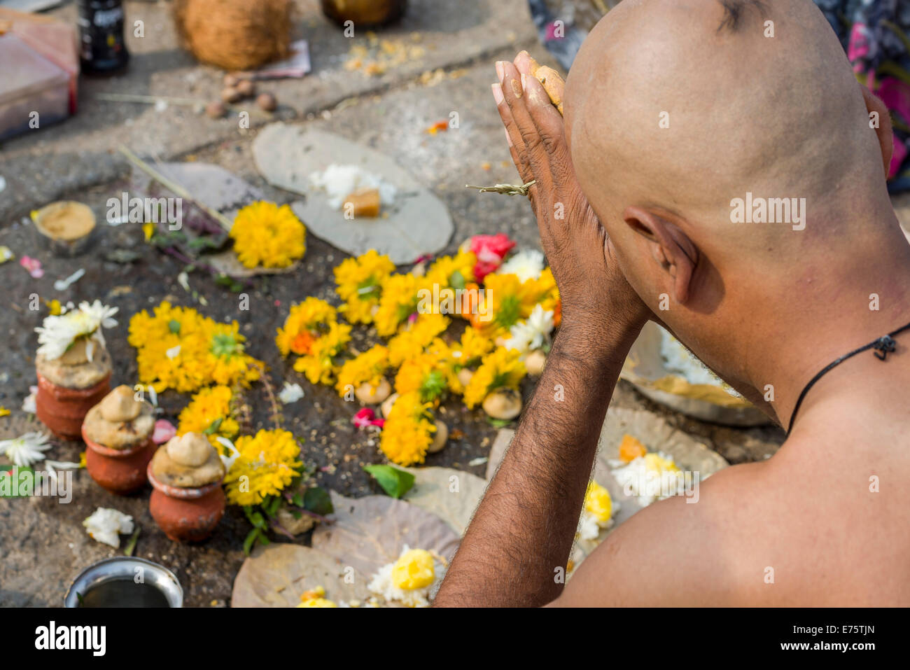 A man is praying during Dashkriya or Asthi Visarjan, a ritual which is performed 10 days after the death of a family member Stock Photo