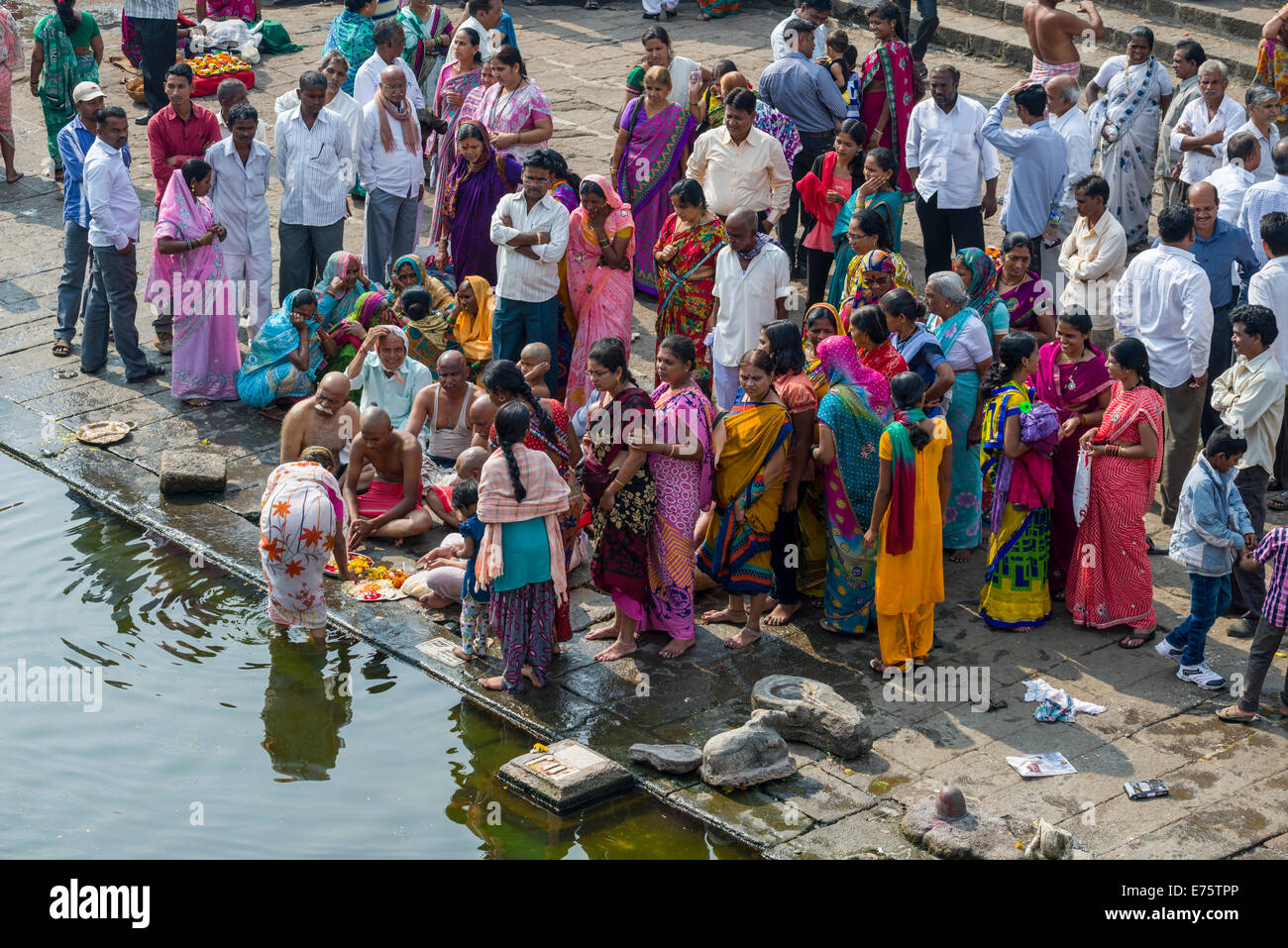 A family and a pandit or priest are performing Dashkriya or Asthi Visarjan, a ritual which is performed 10 days after the death Stock Photo