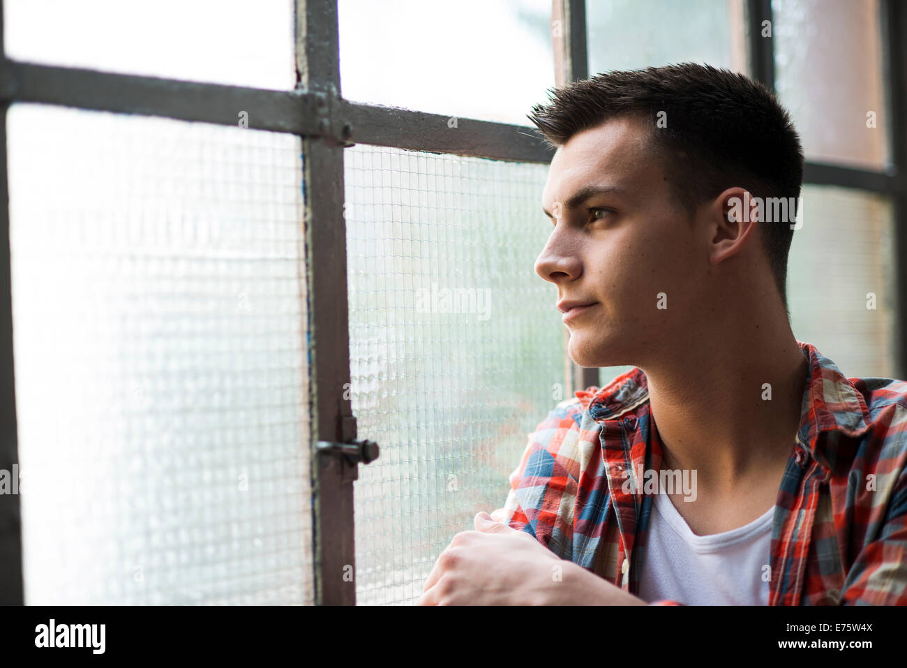 Men Look Out Window Young man looking out of a window Stock Photo - Alamy