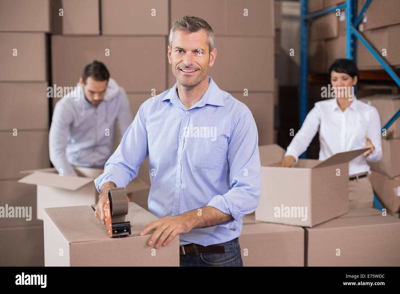 Warehouse workers packing up boxes Stock Photo