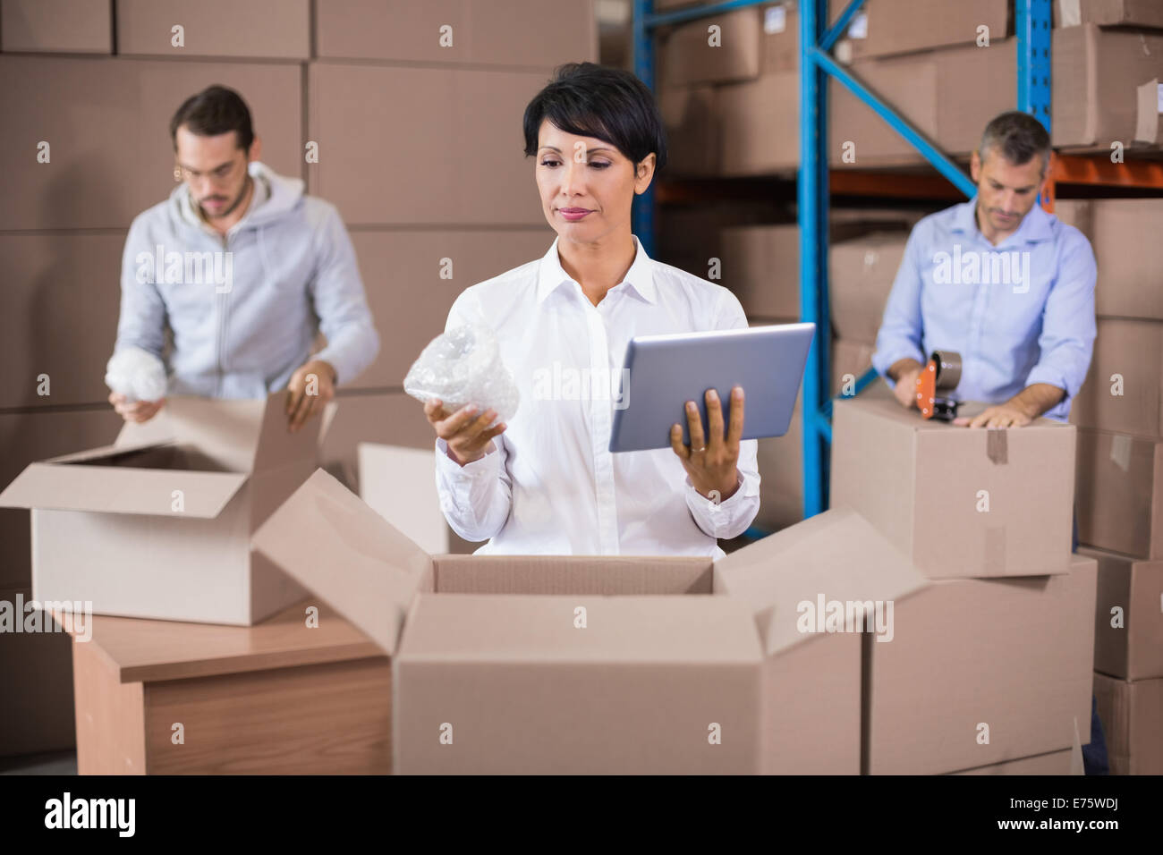 Warehouse workers packing up boxes Stock Photo - Alamy