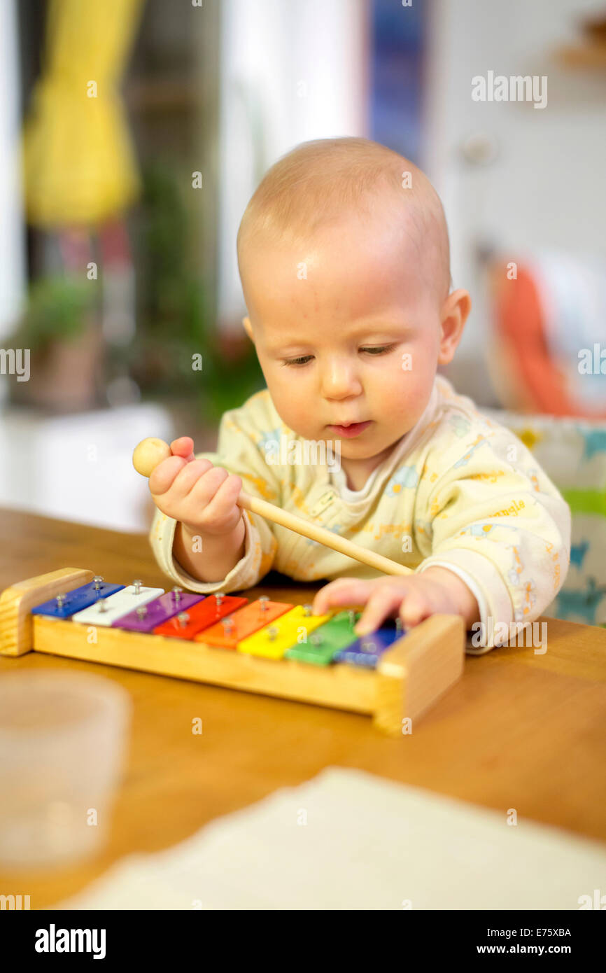 Baby, 8 months, playing with a xylophone Stock Photo Alamy