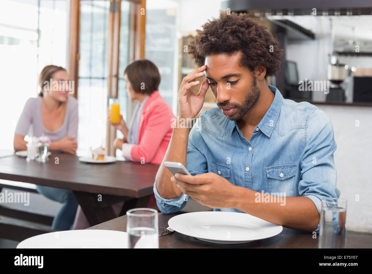 Handsome man sending a text Stock Photo - Alamy