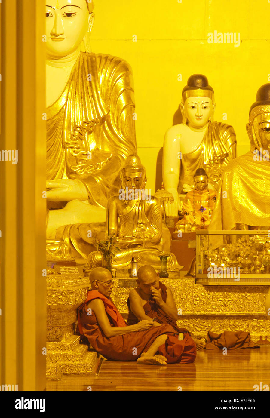 Two Buddhist monks with a mobile phone, Shwedagon Pagoda, Yangon, Myanmar Stock Photo