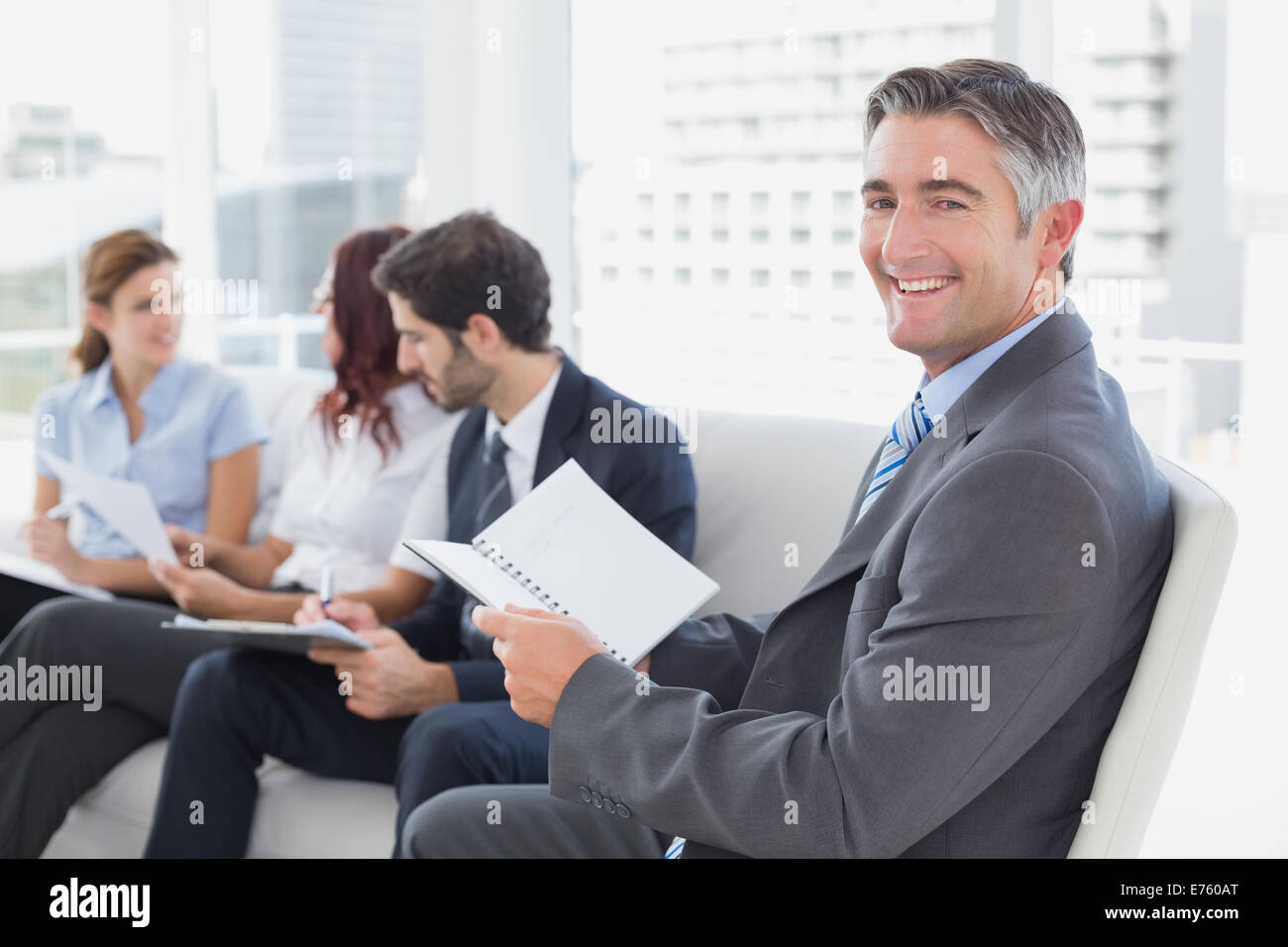 Businessman smiling at the camera Stock Photo - Alamy